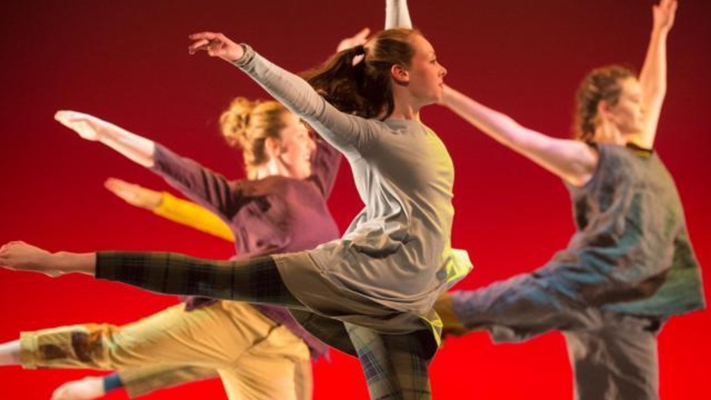 A group of performers dancing together