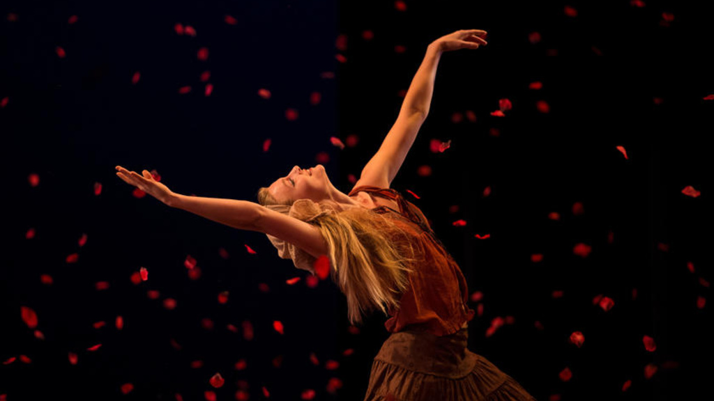 A woman bending backwards with her arms in the air