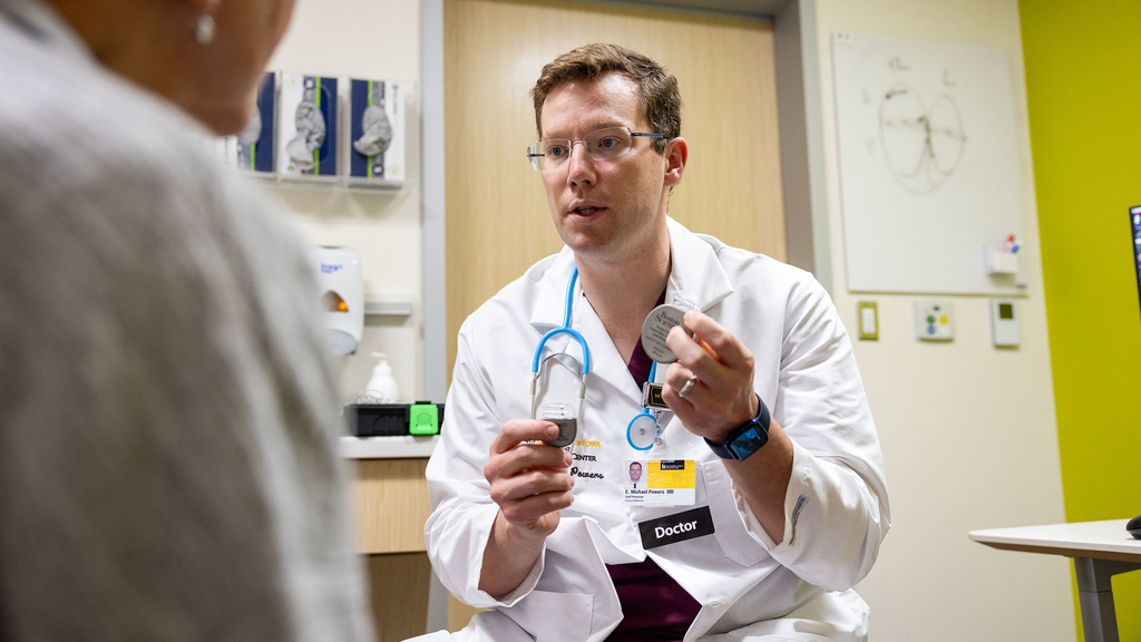 a doctor holding up a medical device