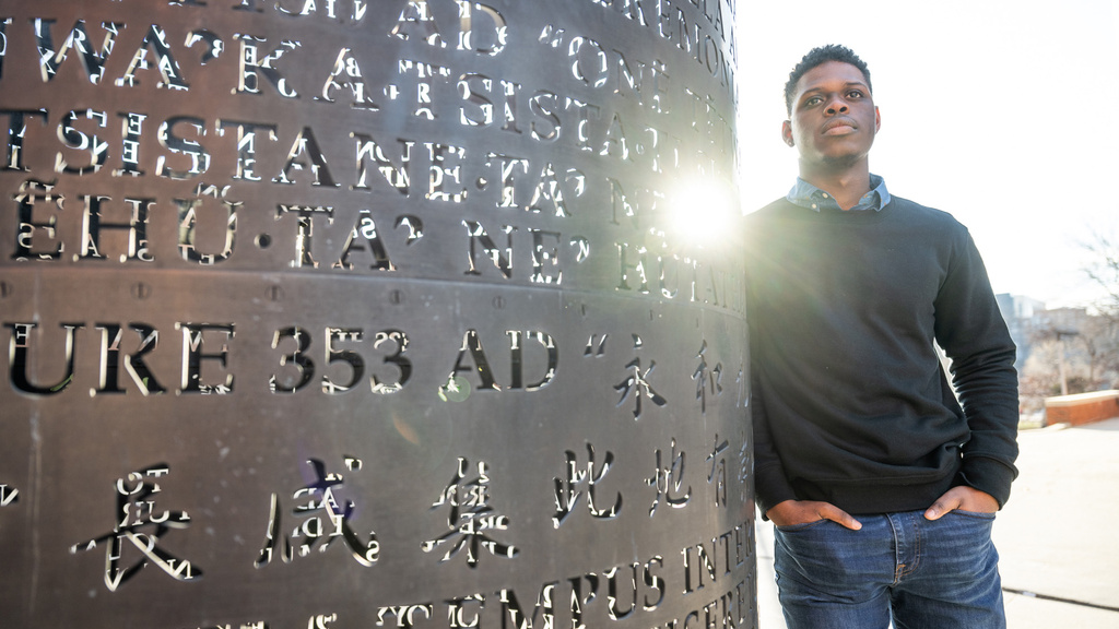 A man leaning on a sculpture