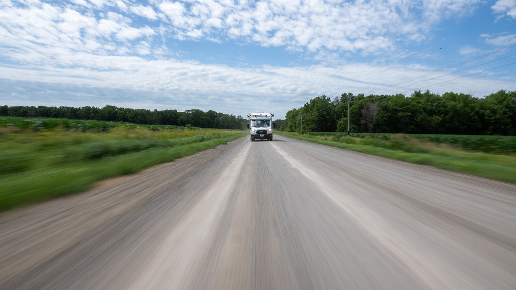 A distant shot of a car driving on a road