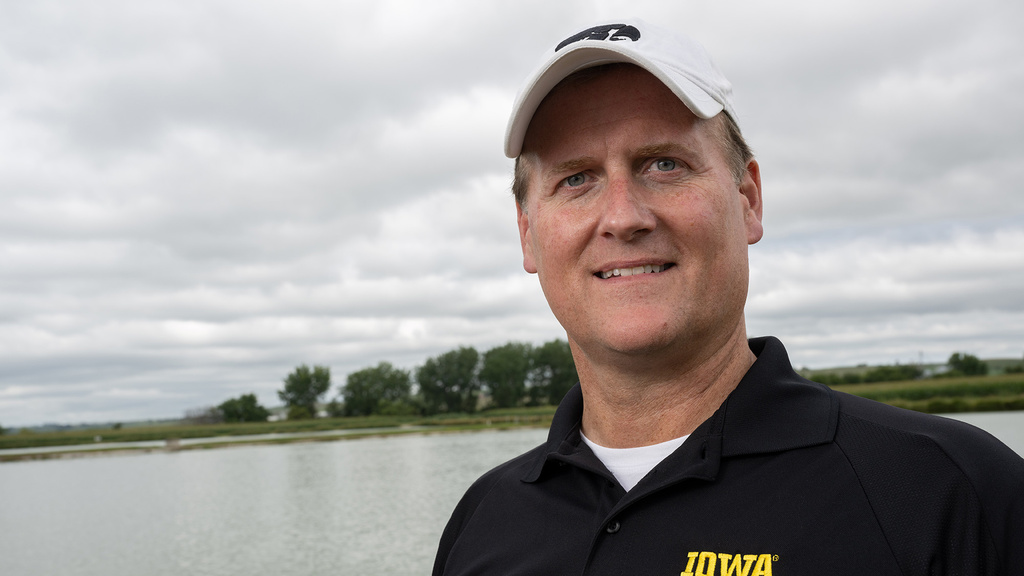 A man smiling with a lake in the background