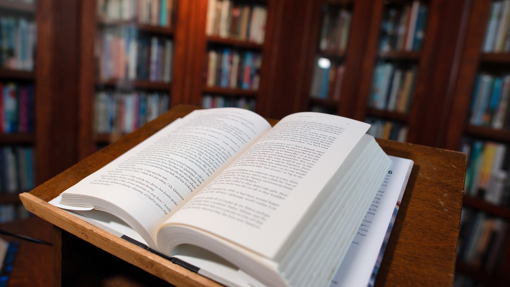 An open book sitting on a lectern