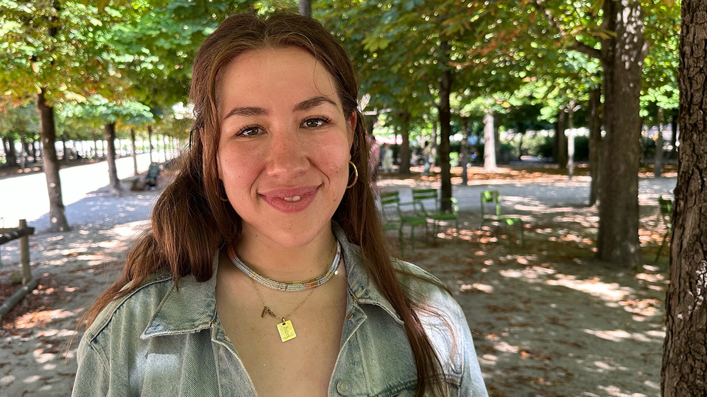 a portrait of a woman on a shaded pedestrian mall