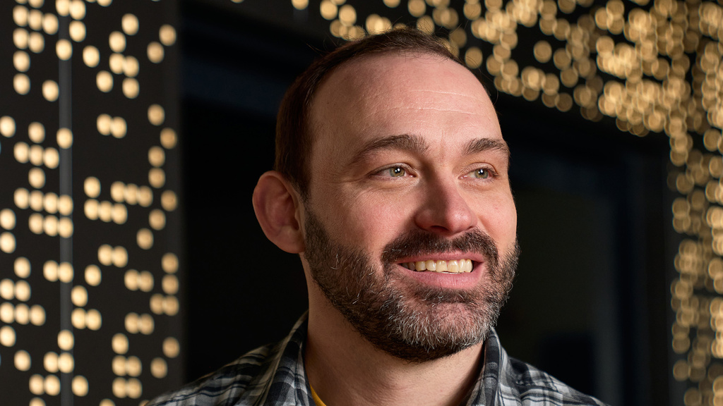 A man staring off into the distance and smiling
