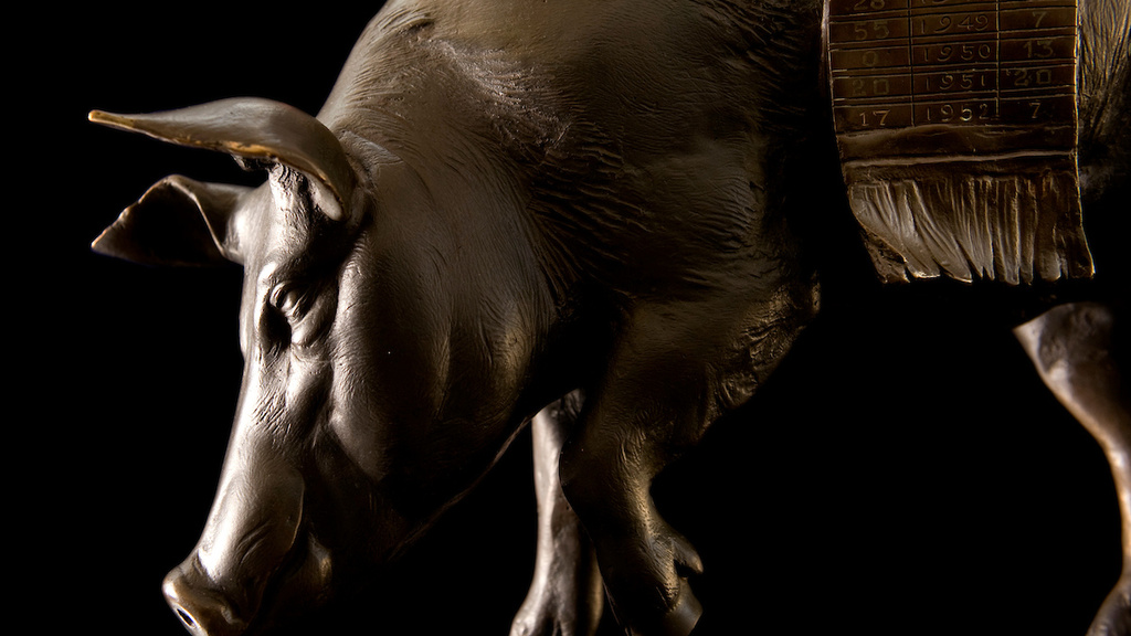 A side angle of a bronze statue of a pig