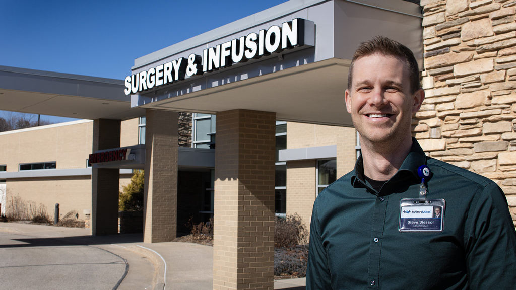 A man standing in front of an emergency room