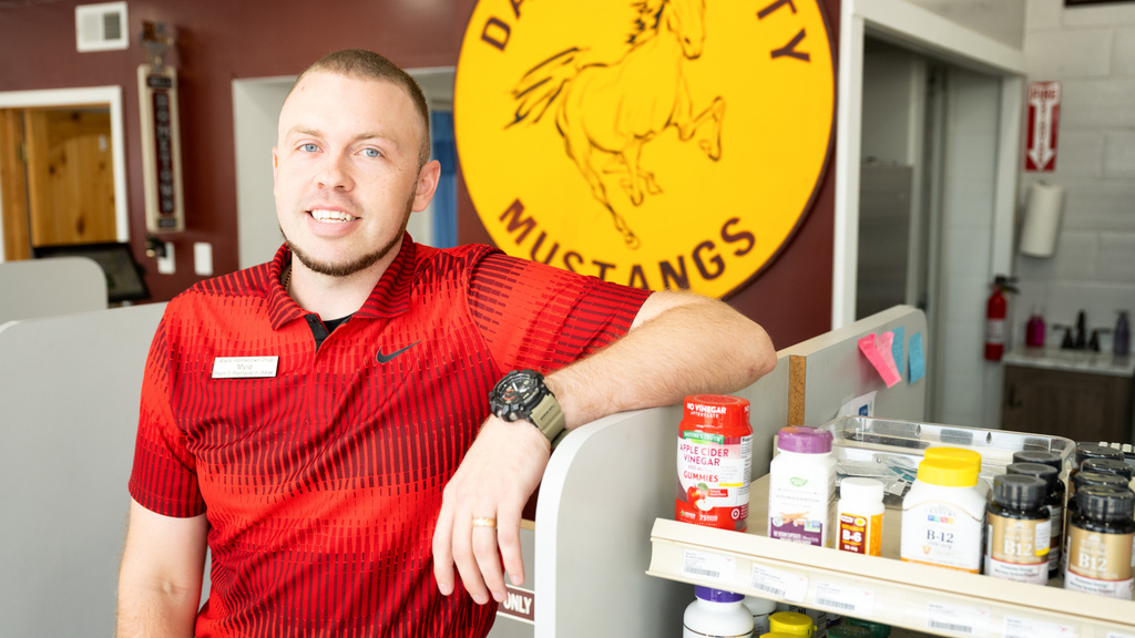 A man leaning on a counter and smiling