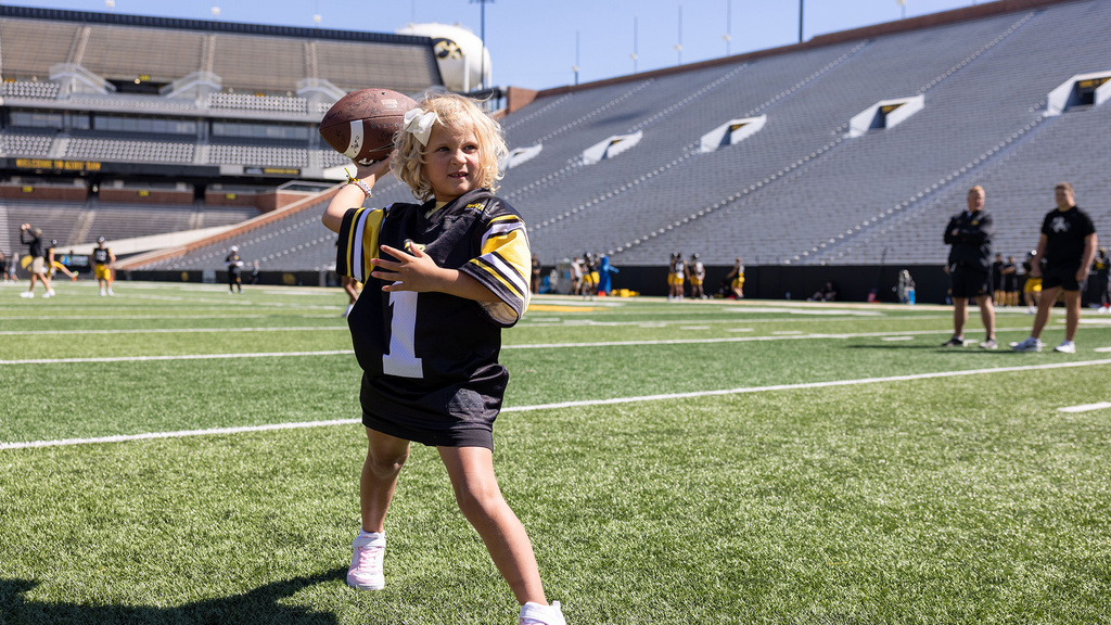 A young girl getting ready to throw a football