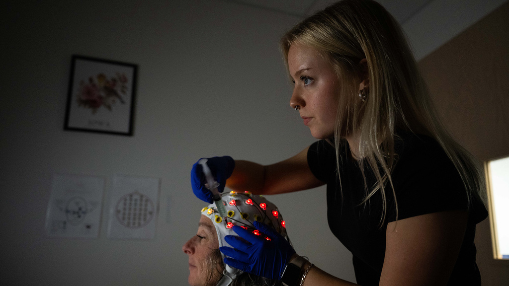 a university of iowa student prepares a subject for a study in the Psychological and Brain Sciences Building