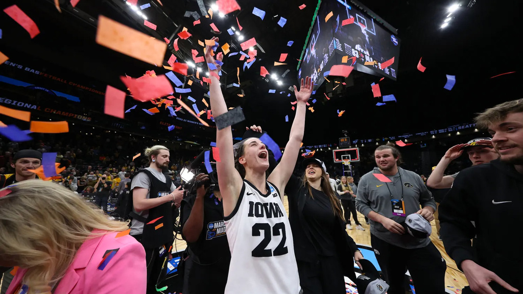 caitlin clark celebrating while confetti falls around her