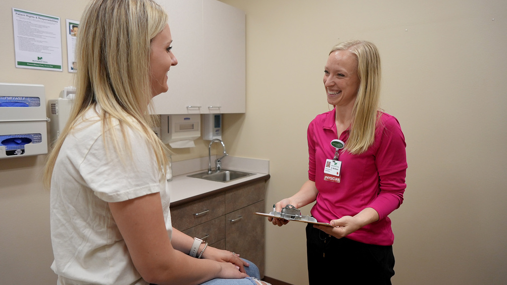 A physician talking to her patient