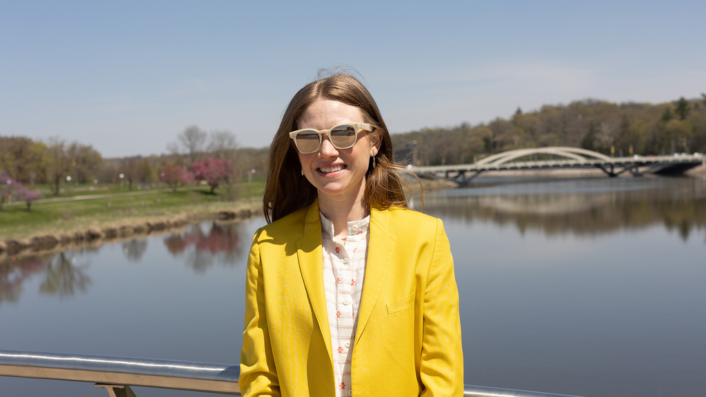 A woman standing on a bridge and smiling