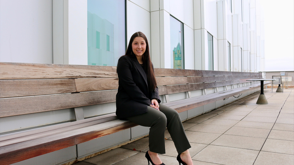 A woman sitting on a bench outside