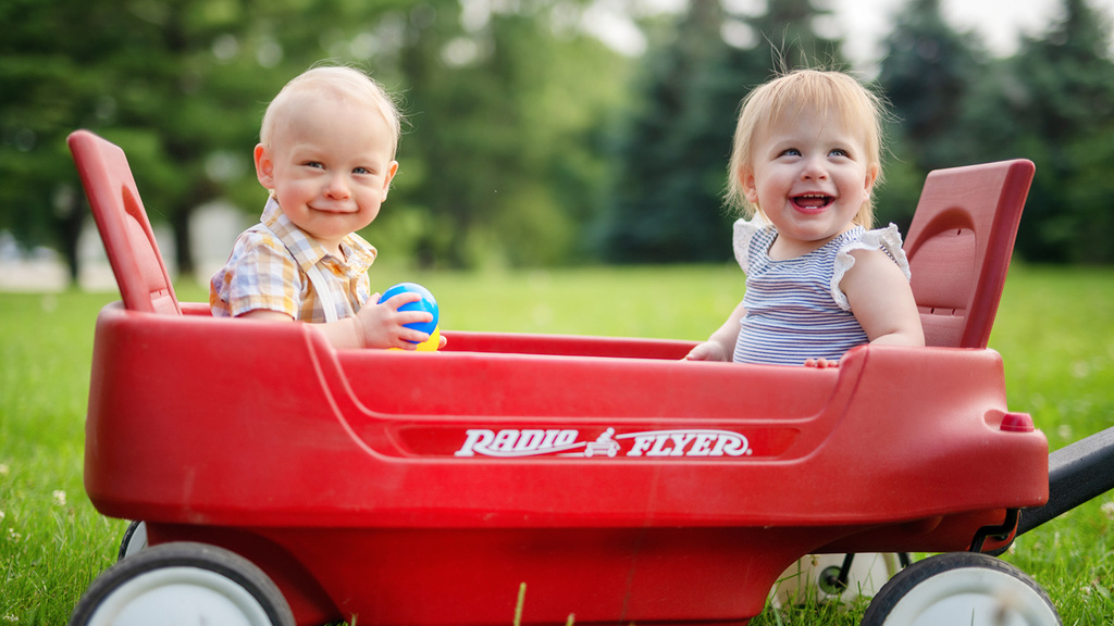 two children sitting in a wagon