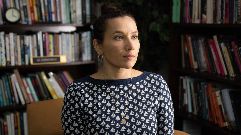Melissa Febos sitting in a reading room