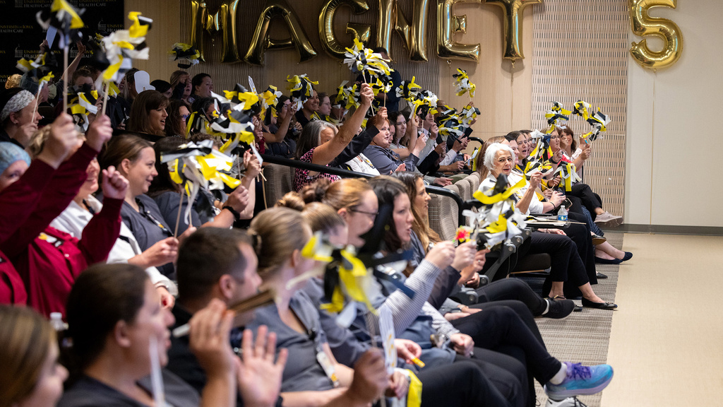 A crowd of people cheering together