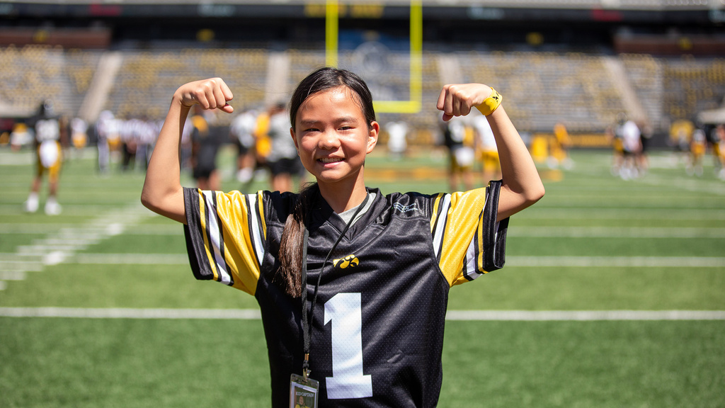 a girl flexing on a football field