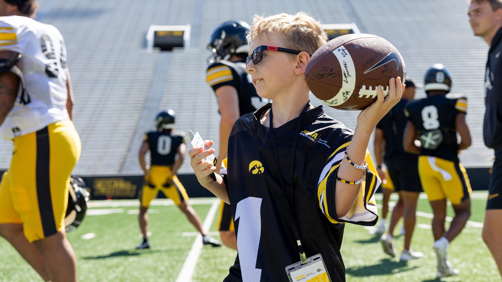 A boy pulling his arm back to throw a football