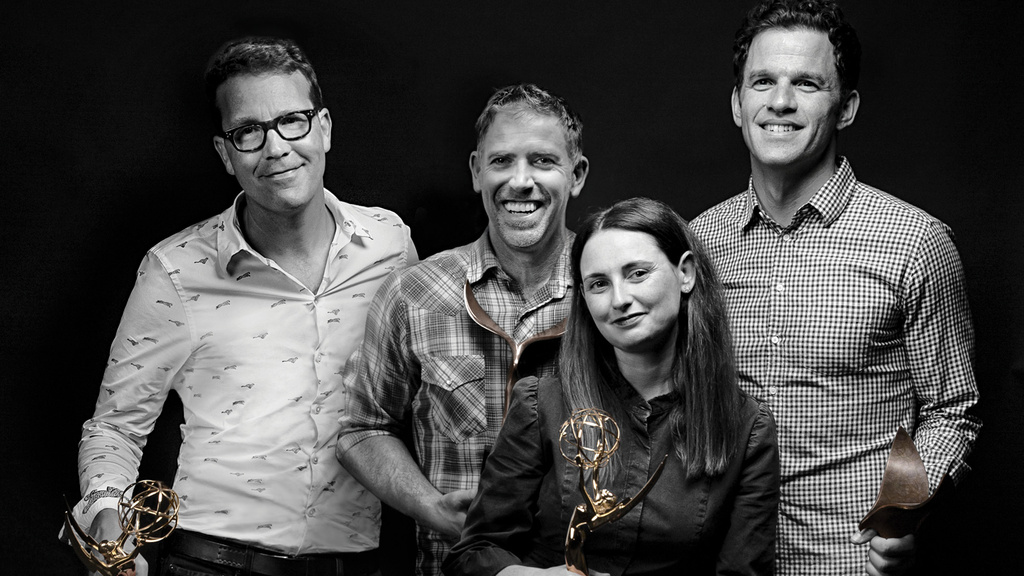 A group of four people holding trophies