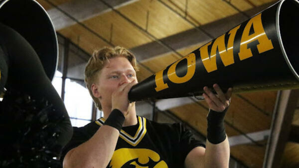 Ethan Dabareiner cheering into an Iowa megaphone