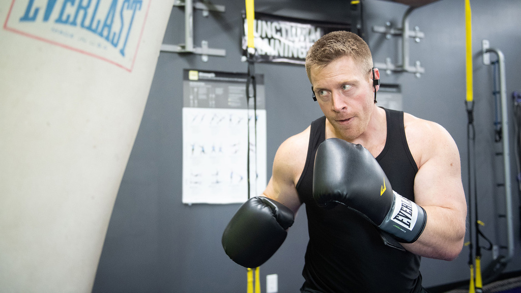 jordan hauck wearing boxing gloves, working out with a heavy bag