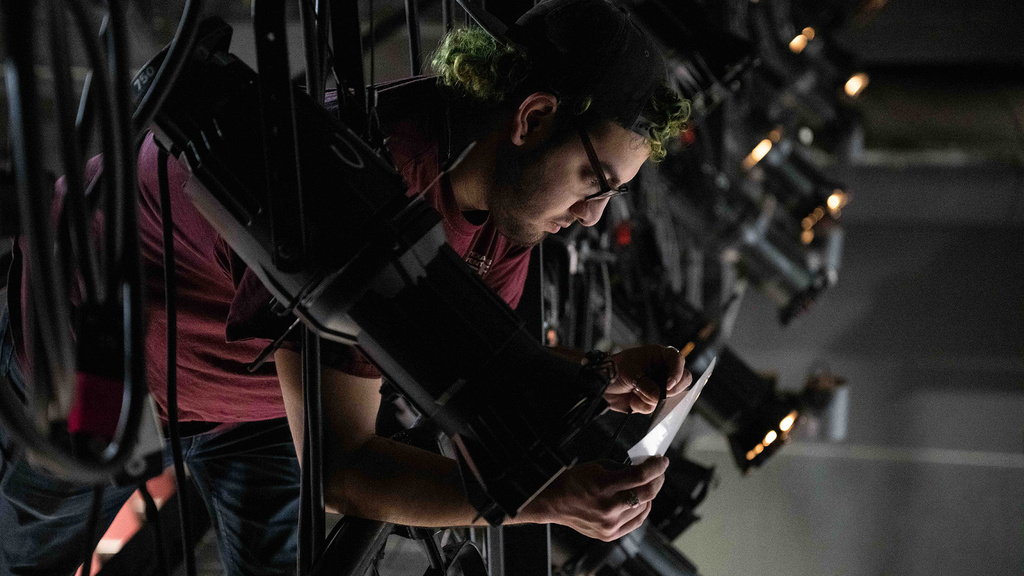 a student working on lighting for a theater production