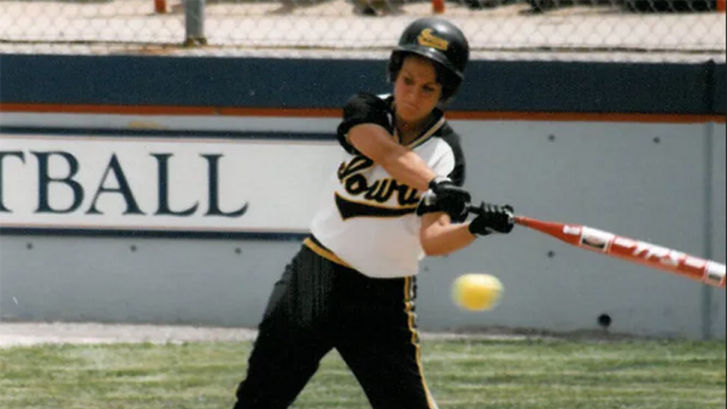 softball player swinging at a pitch