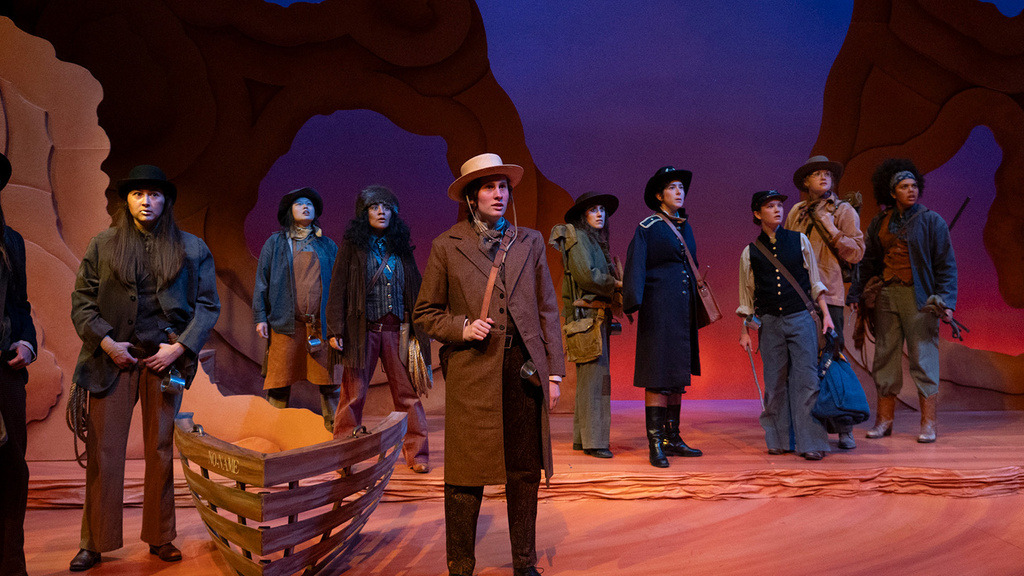 actors on a stage performing a western-themed play