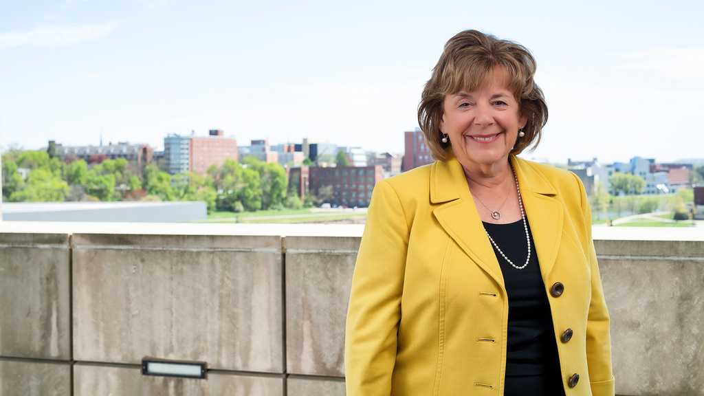 Barbara Wilson standing on a balcony on the University of Iowa campus
