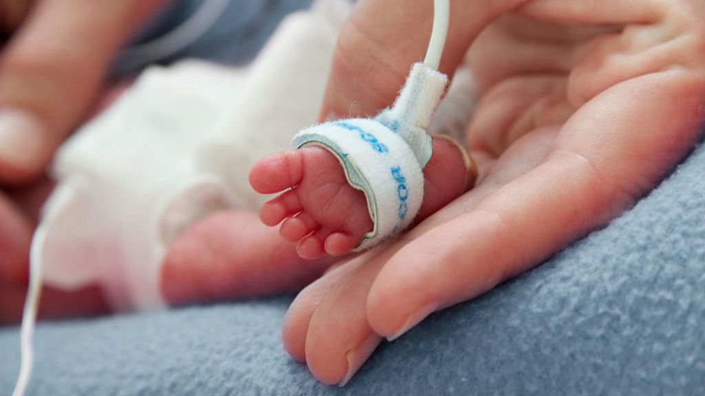 A babies foot being held