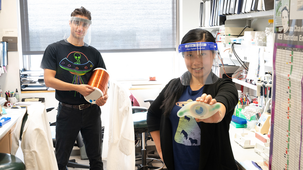 Two people holding up their new device