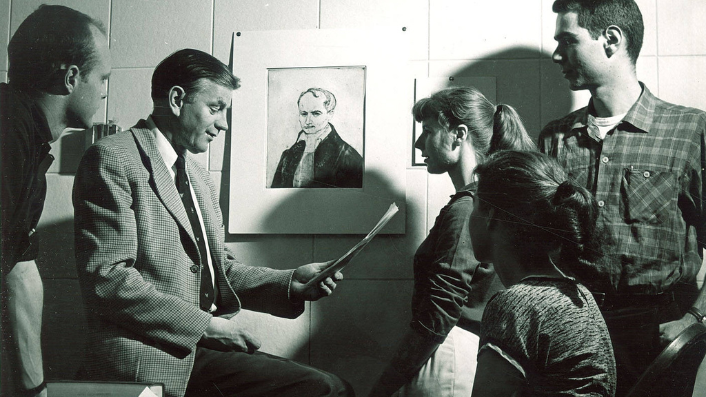 a group of people gathered in front of a drawing
