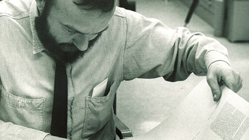 A man reading at a desk