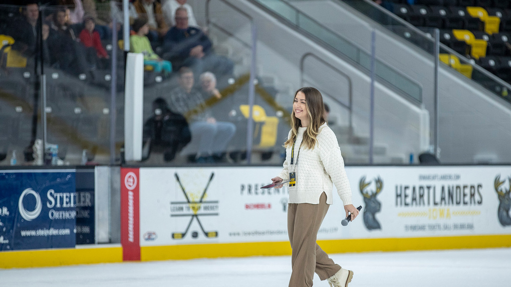 A woman walking out into an ice rank