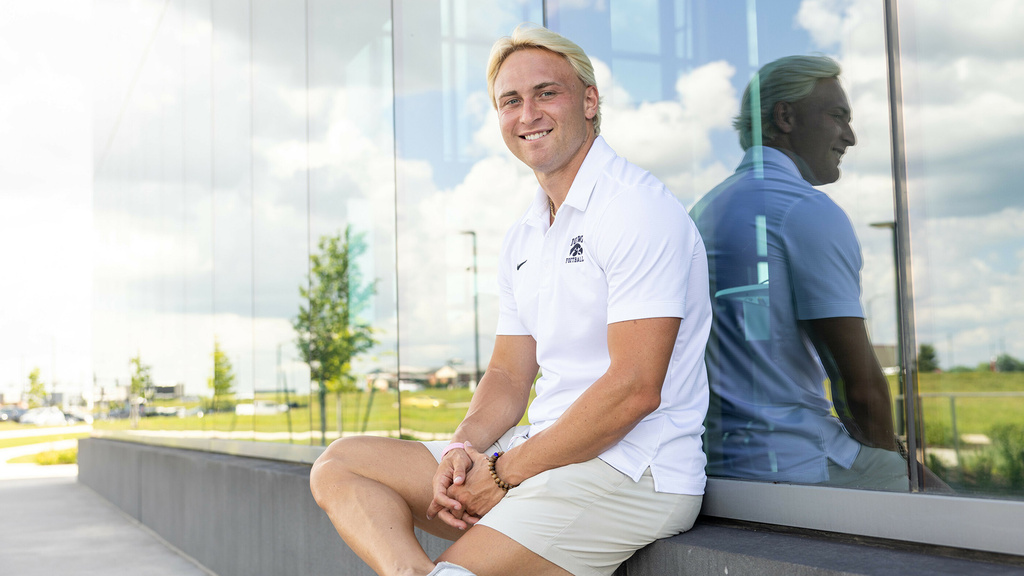 Nick Phelps sitting outdoors on UI Health Care campus
