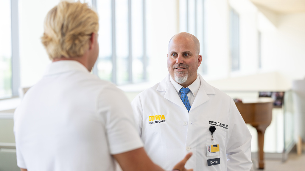 Matthew Karam, MD, speaking with a patient