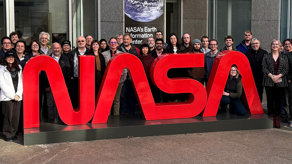 UI TRACERS team posing for a photo by a NASA sign