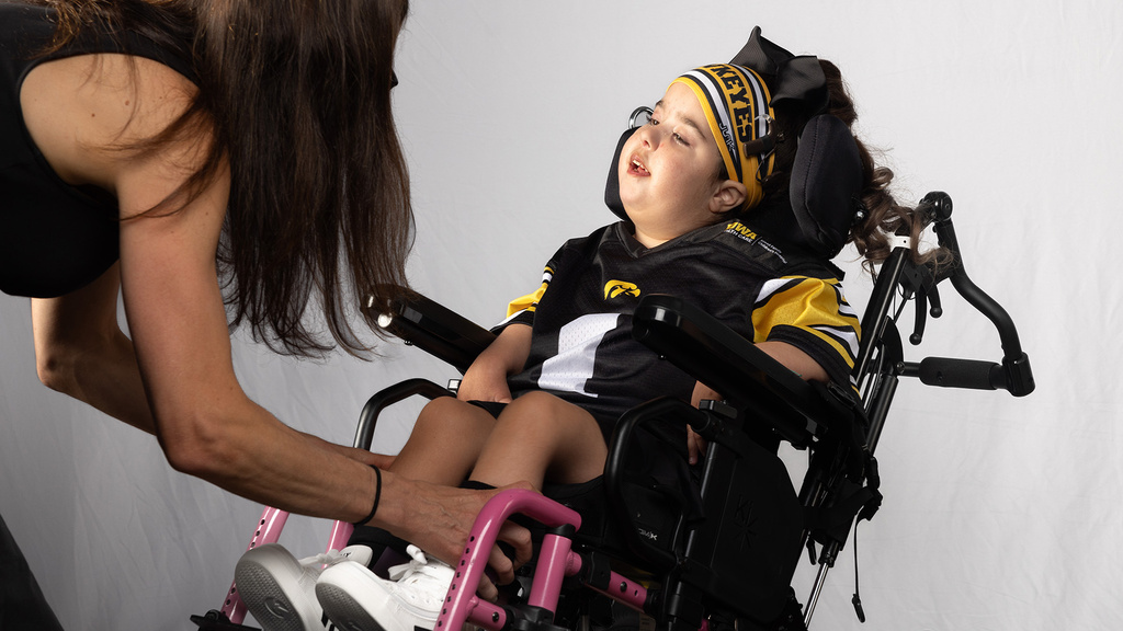 a girl and her mother prepare for a photo shoot