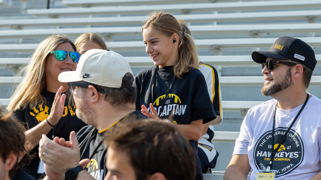 Kid Captain Lily Sebastian with family in the stands at Kinnick Stadium