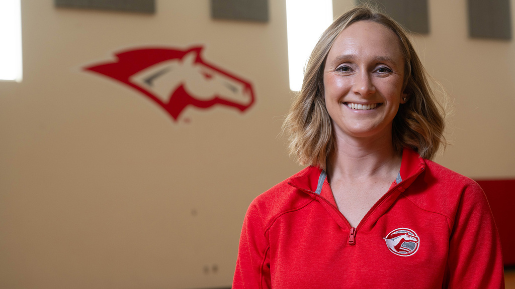 Madison Melchert at Dallas Center-Grimes High School; the school's mascot is painted on the wall in the background