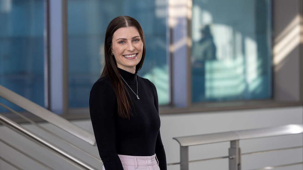 a woman standing in a medical education facility