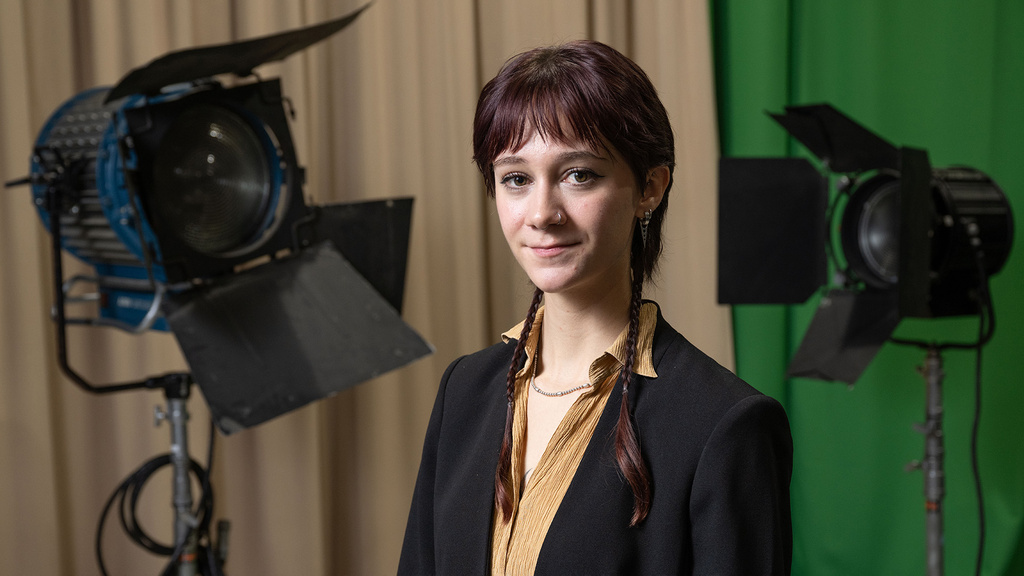 a young woman standing in a studio