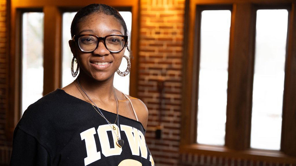 a young woman stands inside the Iowa Memorial Union on the University of Iowa campus