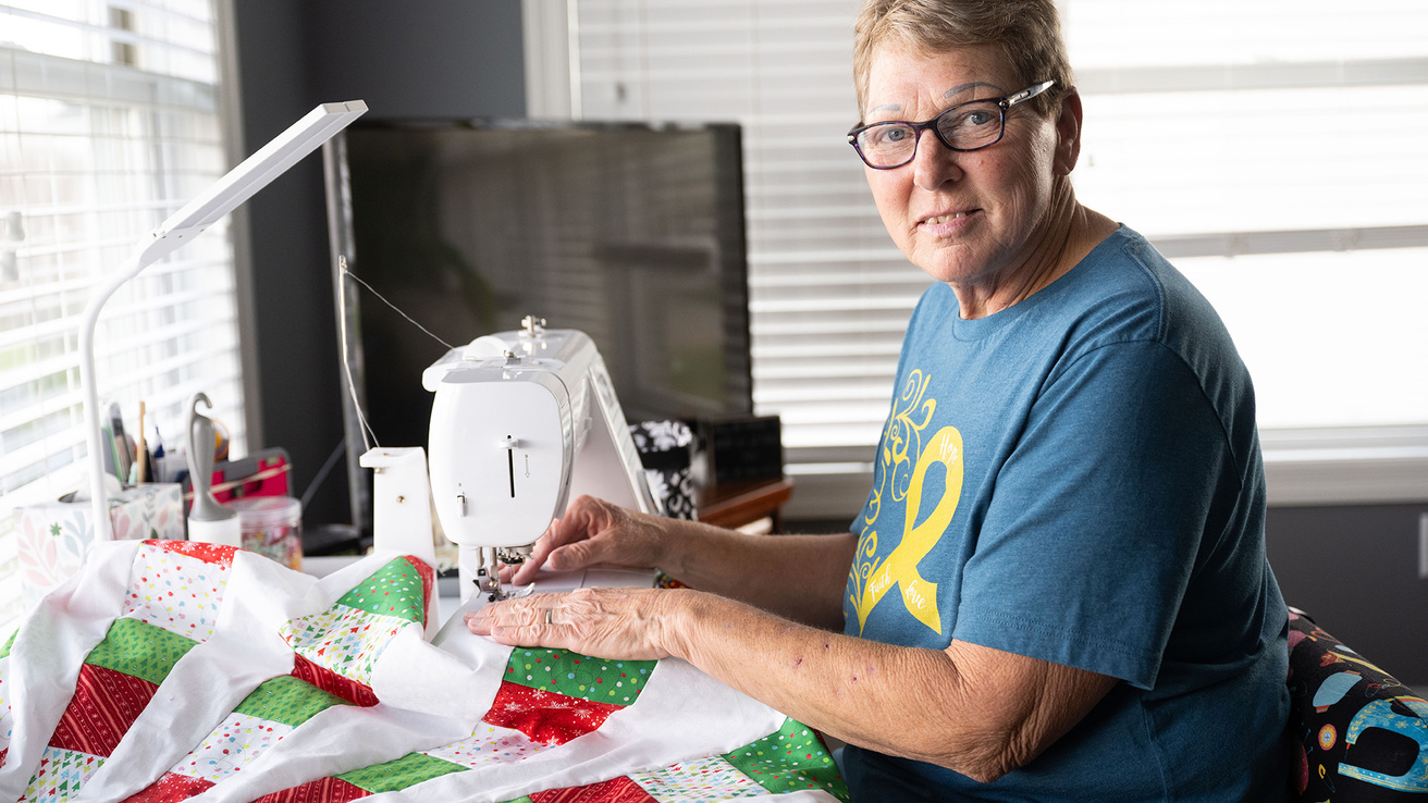 a woman sitting at a sewing table