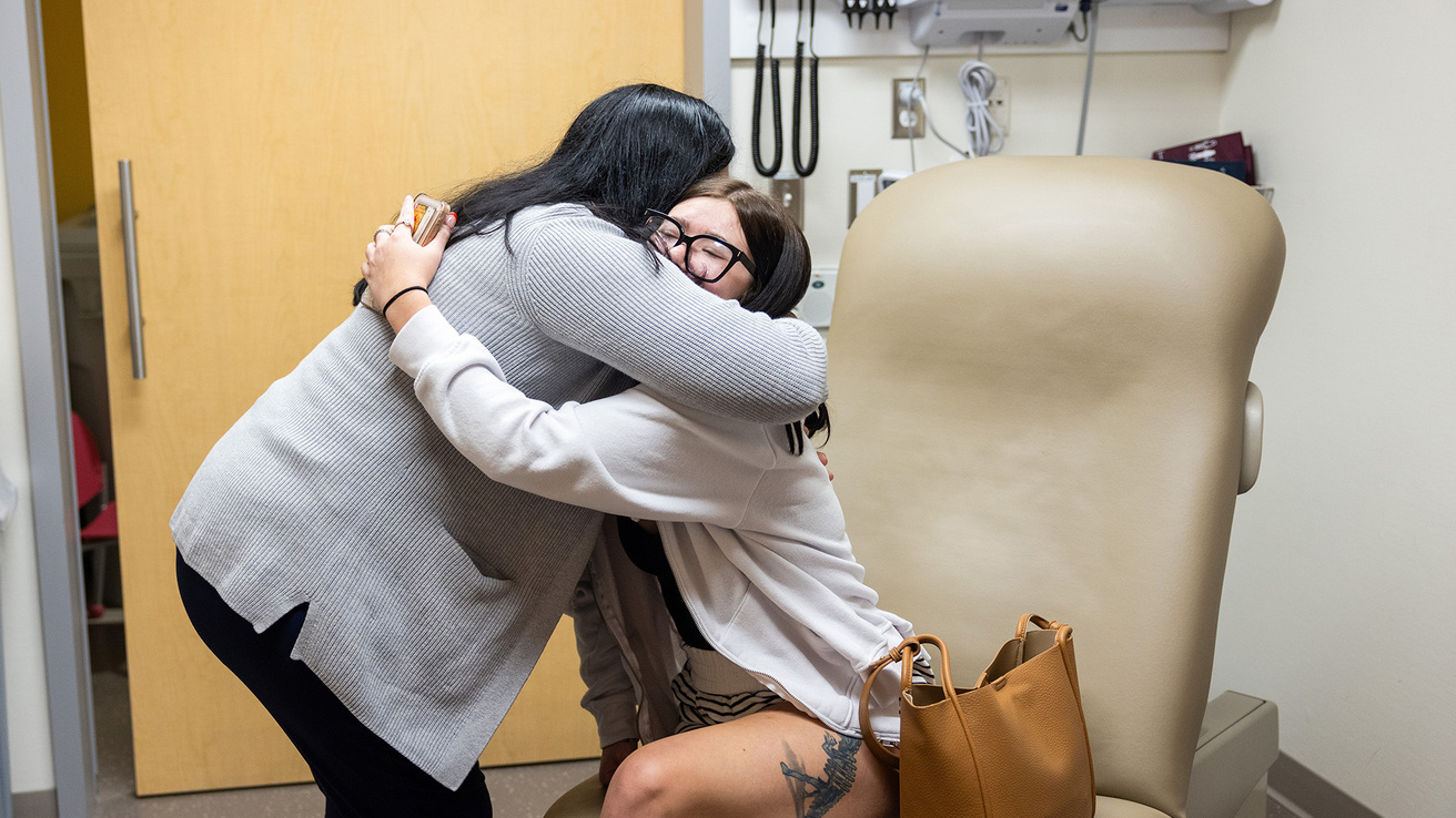 two women embracing at a health care facility
