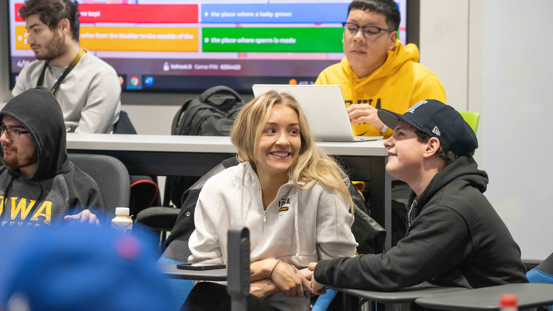 University of Iowa women's basketball player Kylie Feuerbach volunteering in a UI REACH class