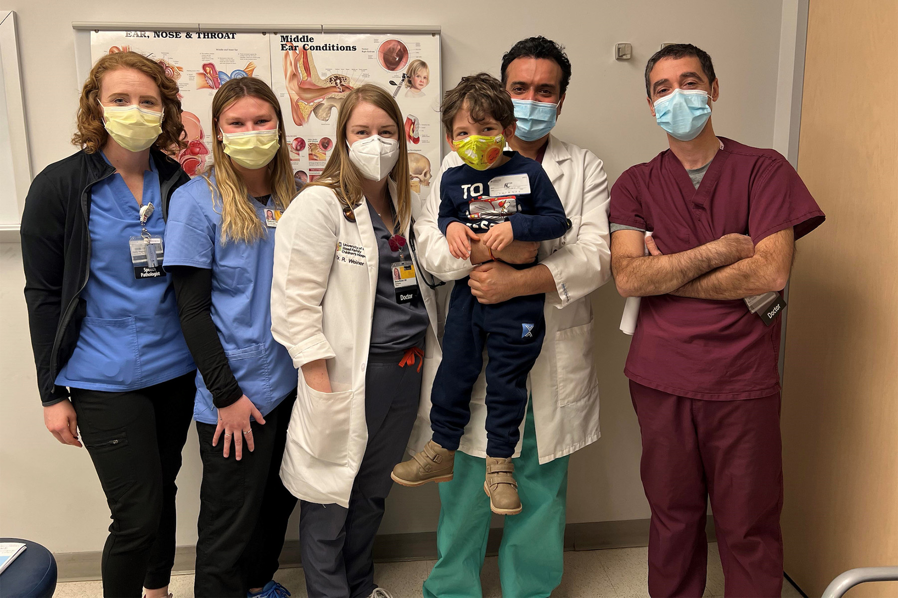 a young boy with health care professionals at the university of iowa